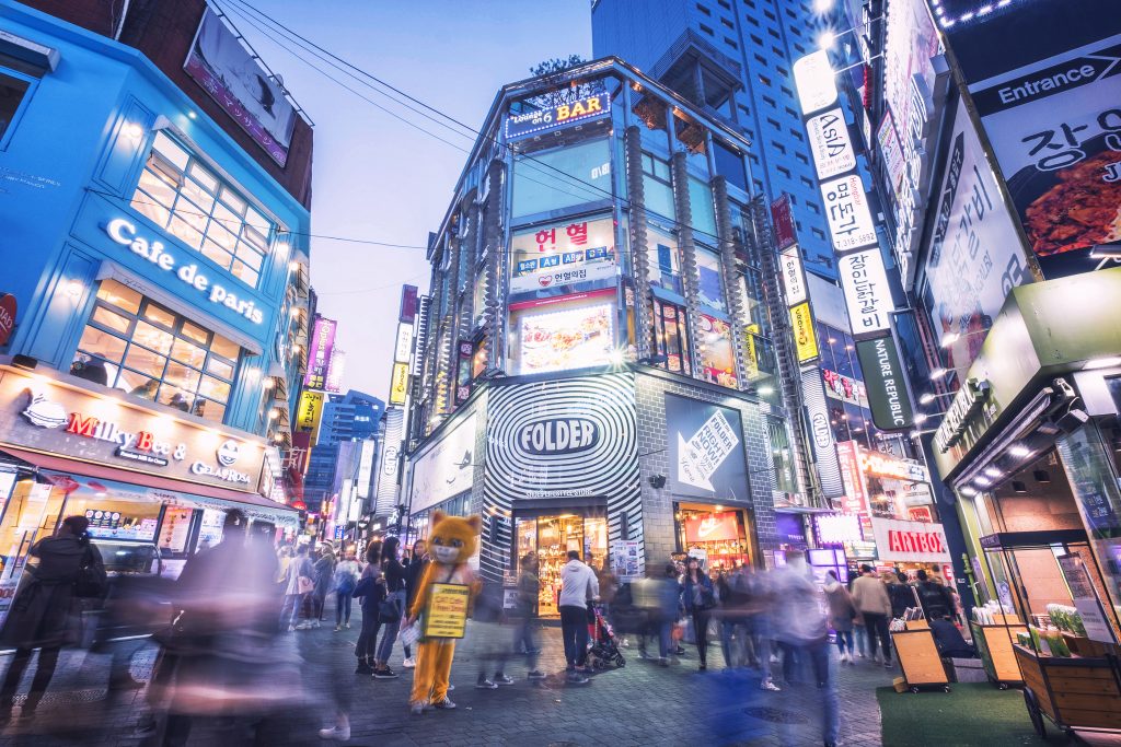 Korean people and tourist walking around Myeong-dong at night for shopping and eating. 