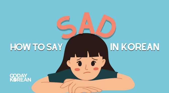 A girl with a sad expression with her chin leaned at the back of her hand