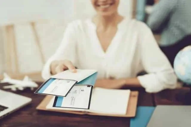 Travel Agent Holding Tickets In Travel Agency