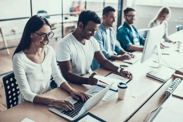 Young Smiling Business People Working In Office.