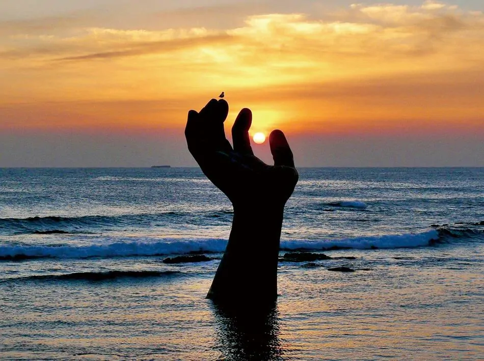 Large arm and hand coming out of the ocean